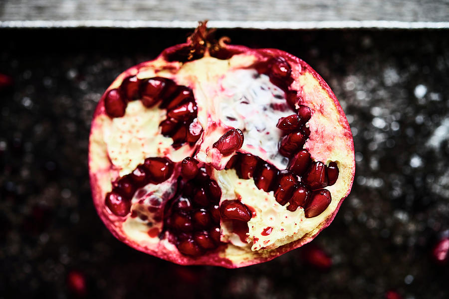 Half Pomegranate On Metal Plate Photograph by Miha Lorencak