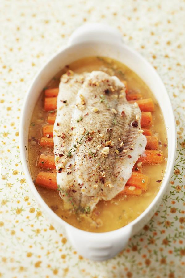 Halibut With Crushed Hazelnuts And Carrots In Thyme Broth Photograph by Barret