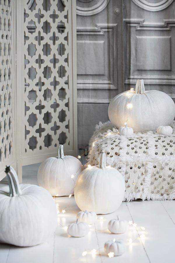 Halloween Arrangement Of White-painted Pumpkins, Fairy Lights And Floor Cushions Photograph by Annette Nordstrom