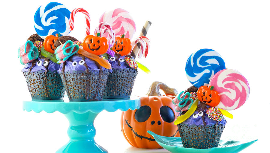 Halloween candyland drip cake style cupcakes with lollipops and  Photograph by Milleflore Images