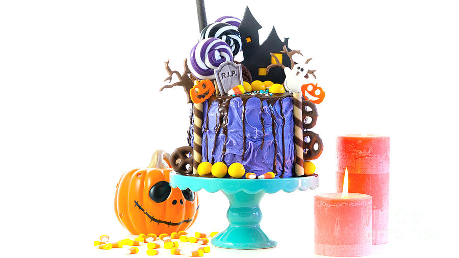 Halloween candyland novelty drip cake on white background. Photograph by Milleflore Images