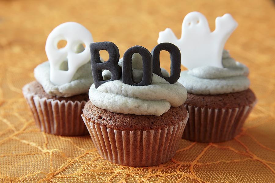 Halloween Cupcakes Decorated With Buttercream Icing And Spooky Cake Toppers Photograph by Simon Scarboro