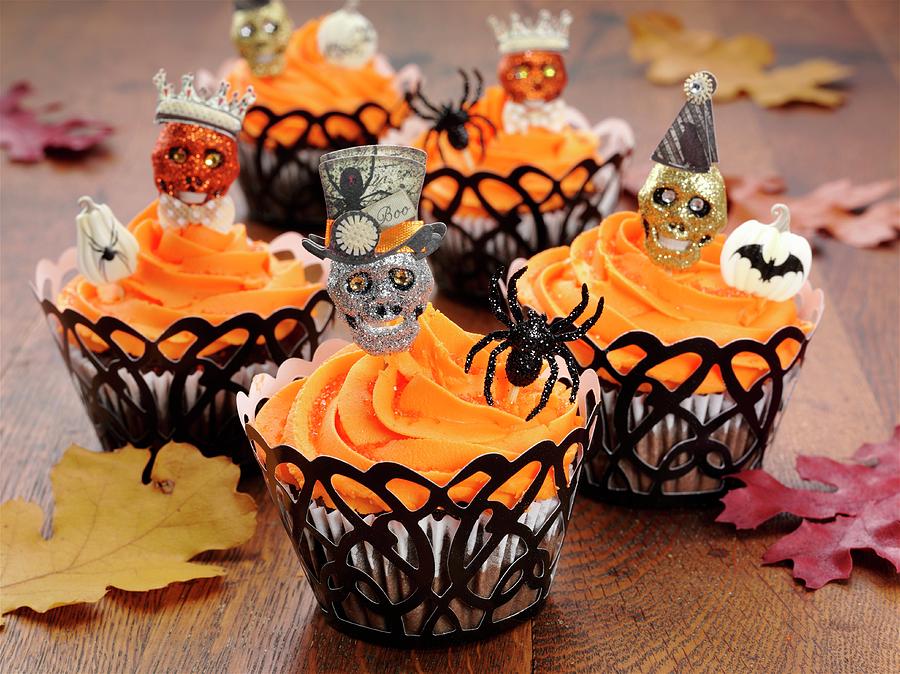 Halloween Cupcakes On An Oak Table With Autumnal Leaves Photograph by Albert P Macdonald