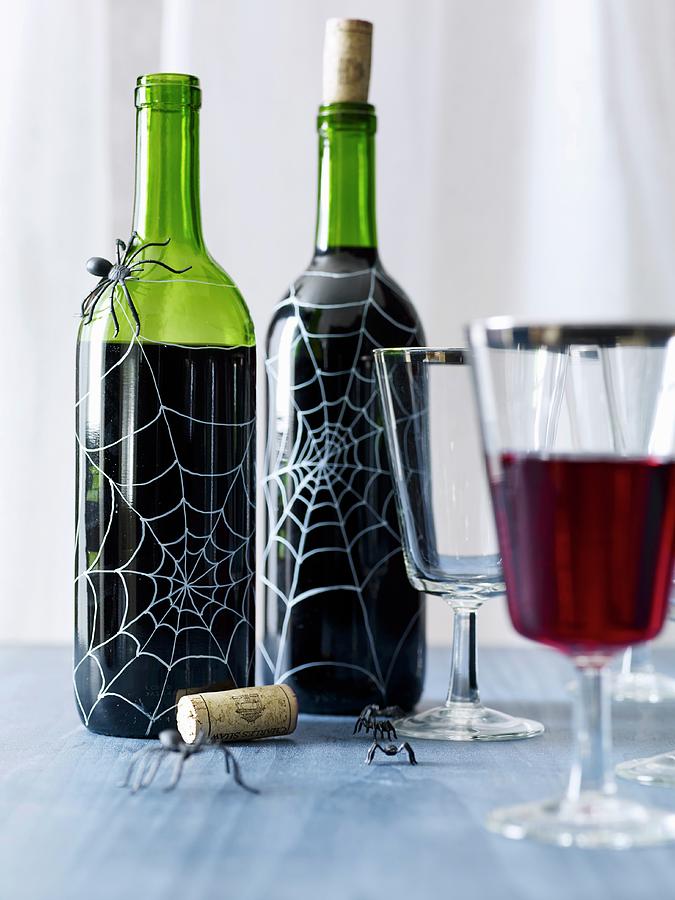 Halloween Wine Bottles Decorated With Spiderwebs Photograph by Antonis Achilleos
