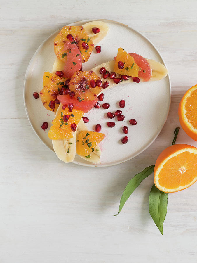 Halved Bananas With Oranges, Grapefruit And Pomegranate Seeds Photograph by Laurange