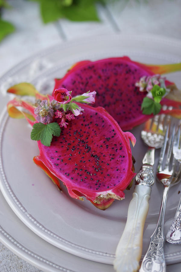 Halved Dragon Fruit With Elegant Silver Cutlery On A Plate Photograph by Angelica Linnhoff
