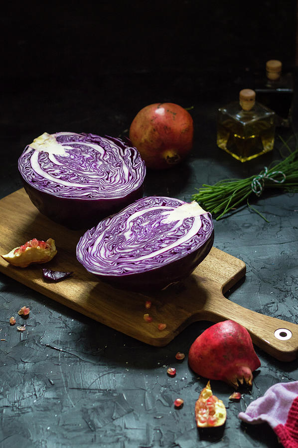 Halved Red Cabbage On Cutting Board With Pomegranate And Chives Photograph by Mateja Zvirotic