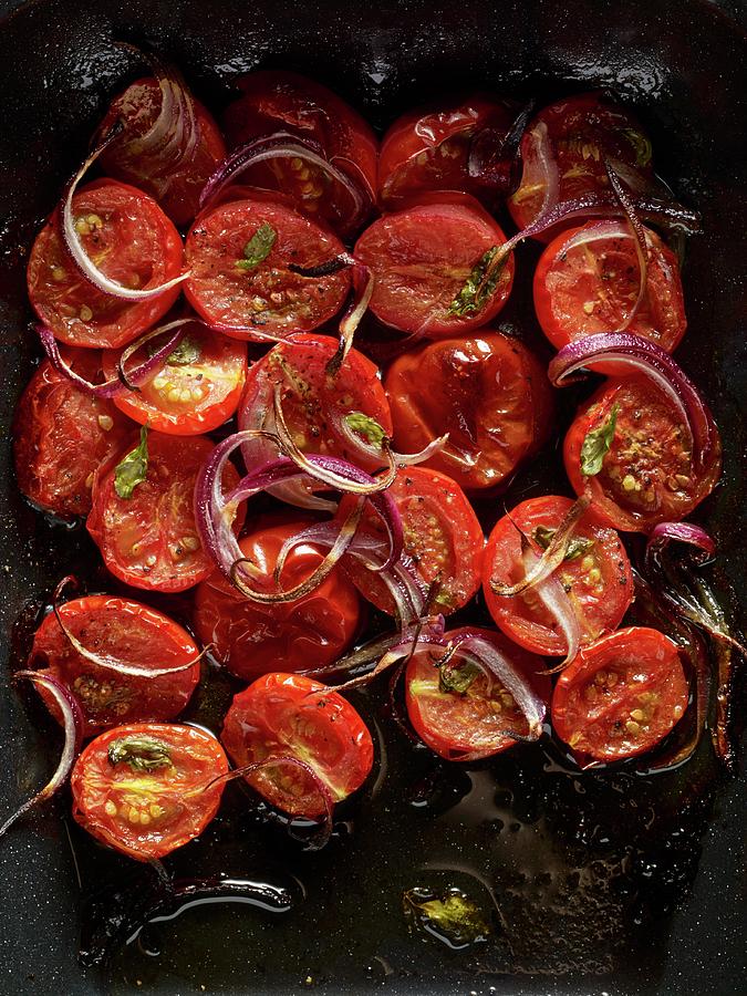 Halved, Roasted Plum Tomatoes With Red Onion Slices And Basil Leaves In A Roasting Tin Photograph by Atkinson / Sue Dr.