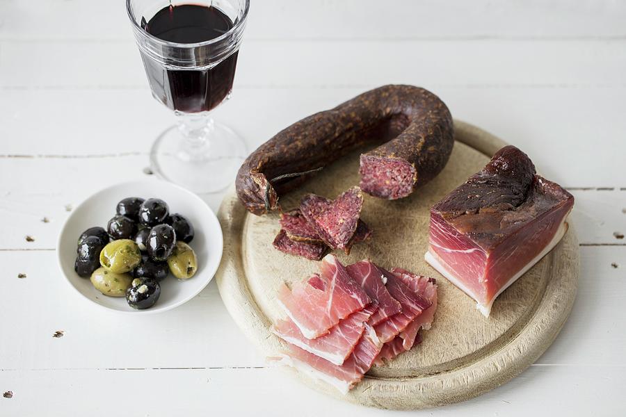 Ham And Salami With Olives And Red Wine Photograph by Nicole Godt