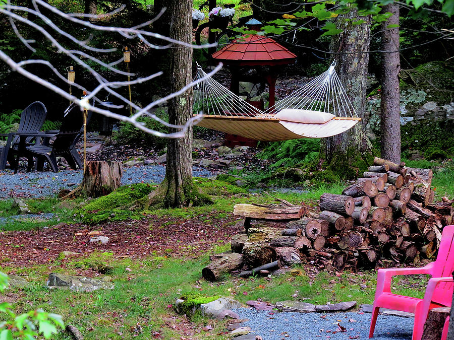 Hammock at a Mountain Retreat with Firewood Pile and Tiki Torches Photograph by Linda Stern