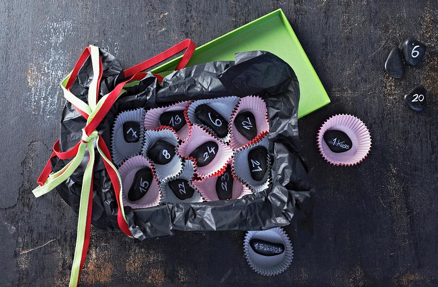 Hand-crafted Advent Calender Made From Small Paper Cake Cases And Black Pebbles Photograph by Bodo Mertoglu