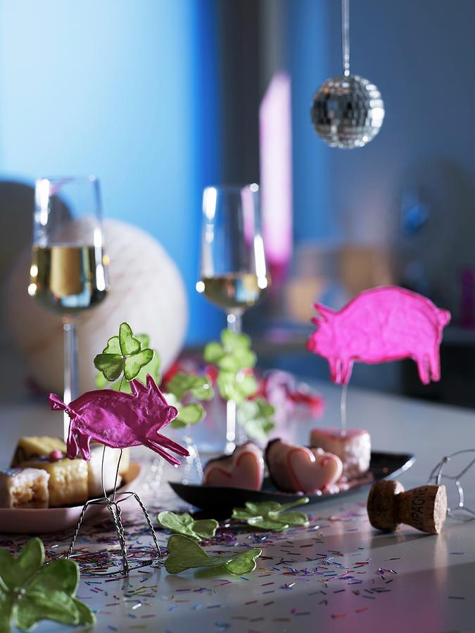 Hand-crafted Animal Figures And Petits Fours On Dishes, With Glasses Of Sparkling Wine In The Background Photograph by Matteo Manduzio