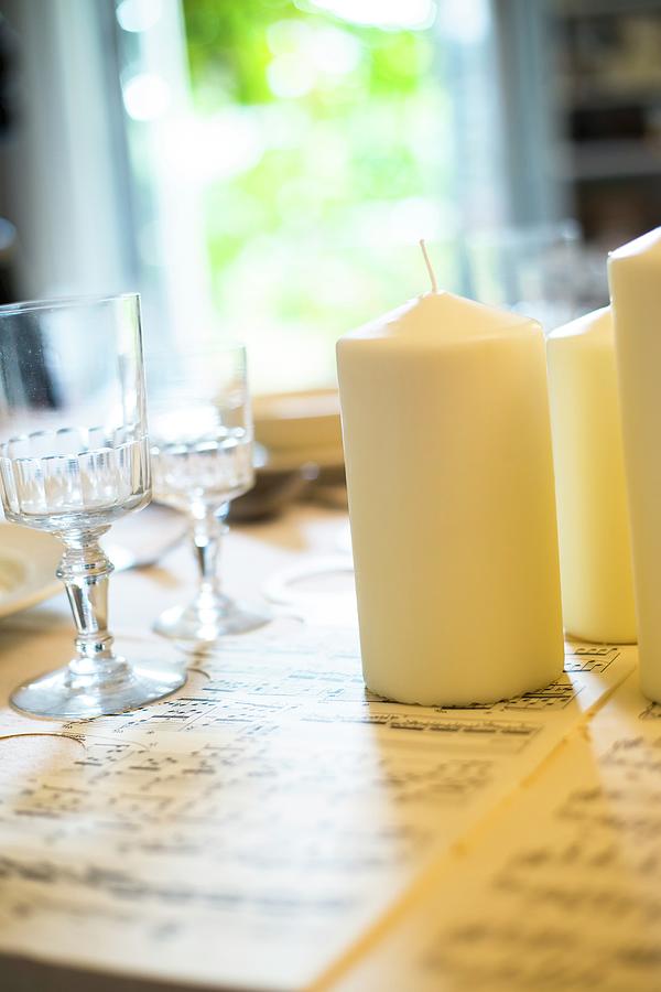 Hand-crafted Festive Table Runner Made From Sheet Music With White Pillar Candles And Crystal Glasses Photograph by Ivan Autet