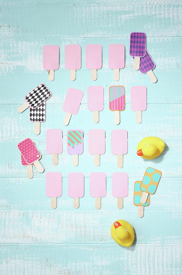 Hand-crafted Pelmanism Set In Shape Of Ice Lollies On Light Blue Surface Photograph by Thordis Rggeberg