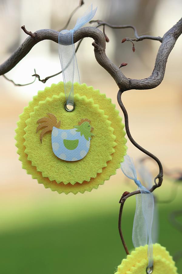 Hand-crafted, Yellow Felt Rosettes With Easter Motifs Hanging From Branch Photograph by Ruth Laing