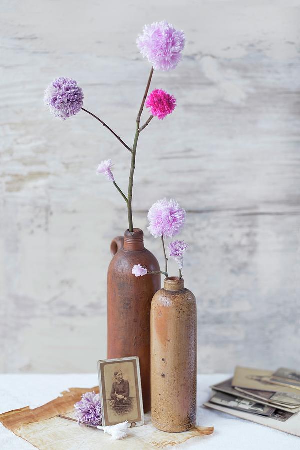 Hand-made, Artificial, Lilac Pompom Flowers In Stoneware Vases Photograph by Sabine Lscher
