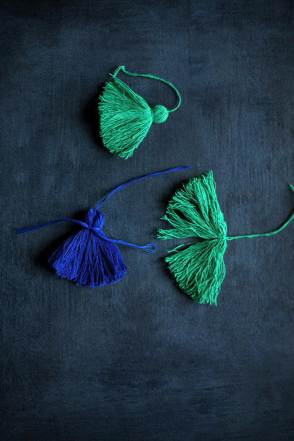 Hand-made Green And Blue Tassels On Black Surface Photograph by Alicja Koll