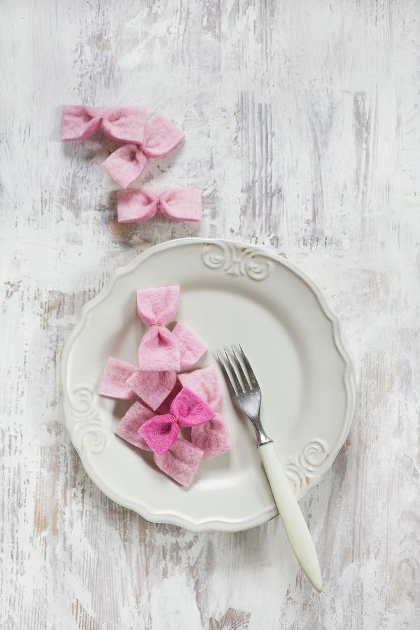 Hand-made Pink Bows On White Plate Photograph by Alicja Koll