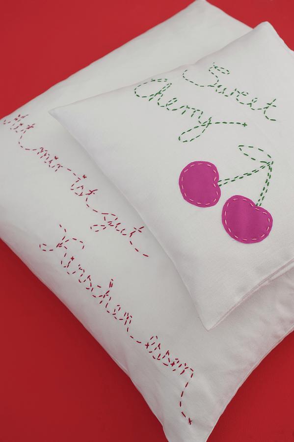 Hand-made Scatter Cushions With Embroidered Mottos And Cherry Motif Photograph by Studio27neun