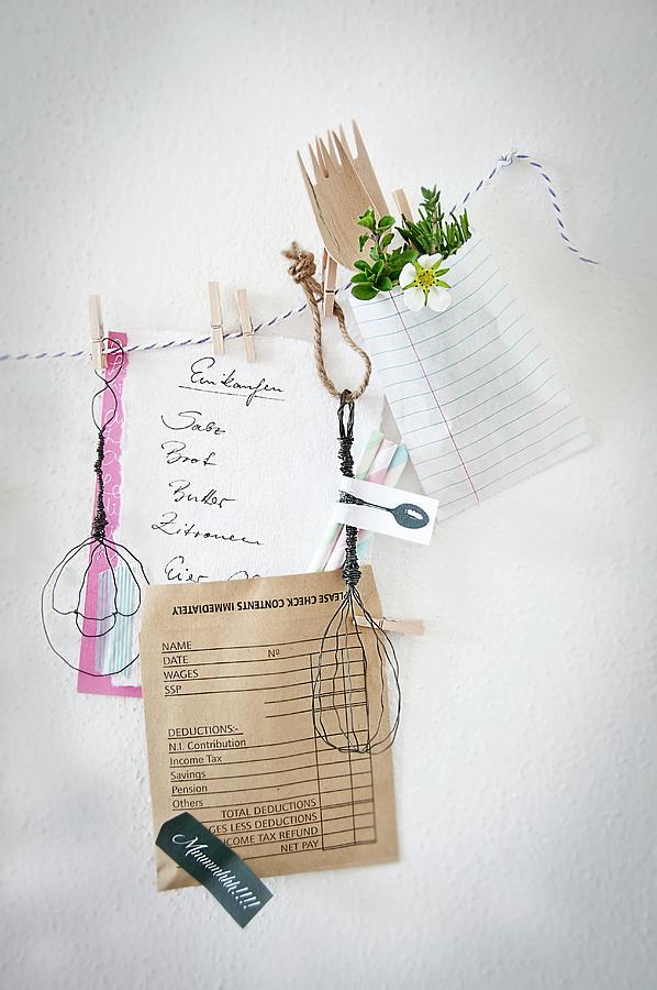 Hand-made Wire Utensils And Shopping List Clipped To Cord With Clothes Pegs Decorating Kitchen Wall Photograph by Cornelia Weber
