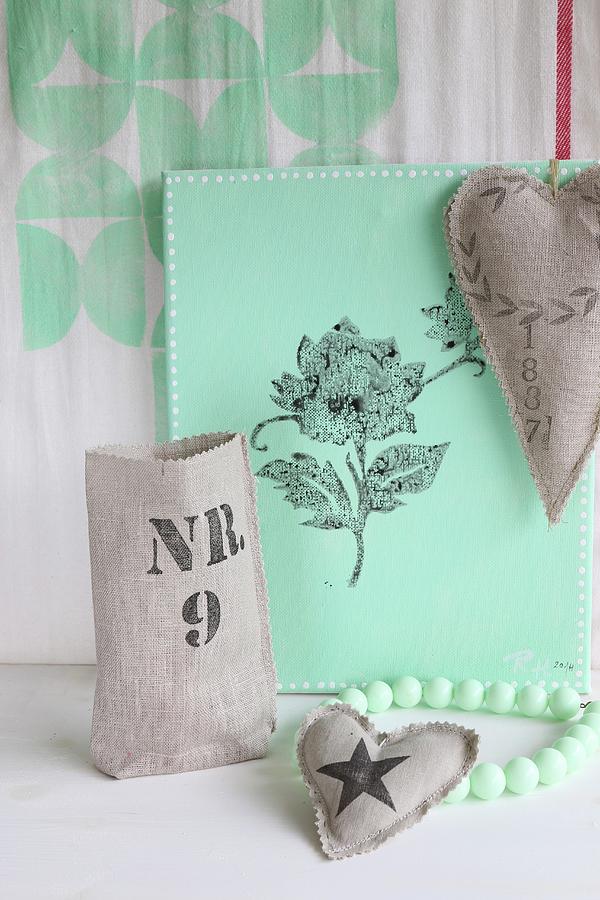 Hand-printed, Heart-shaped Linen Cushions In Front Of Mint-green Canvas Printed With Floral Motif Photograph by Regina Hippel