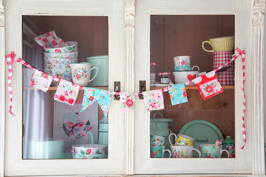Hand-sewn Bunting And Floral Crockery On Shelves Of Kitchen Dresser Photograph by Syl Loves