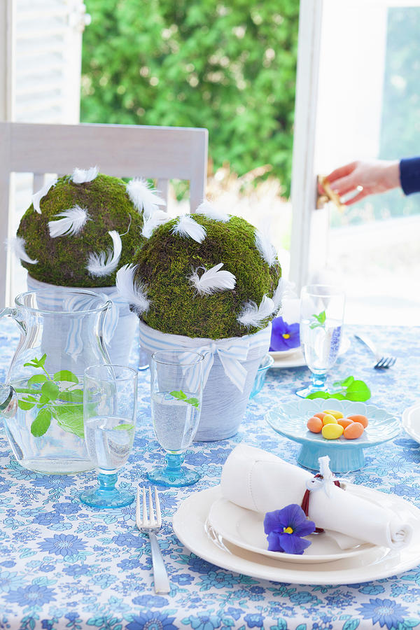 Handmade Moss Balls With Feathers Decorating Easter Table Photograph by Studio Lipov