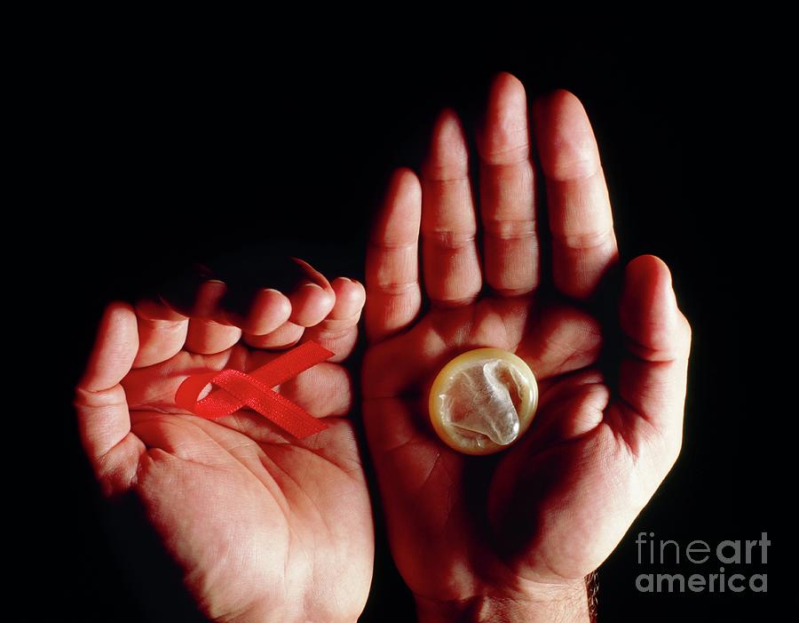 Hands Hold An Aids Red Ribbon And A Condom Photograph By Oscar Burrielscience Photo Library