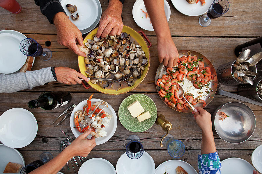 Hands Serving Shellfish Meal Around Photograph by Lisa Romerein