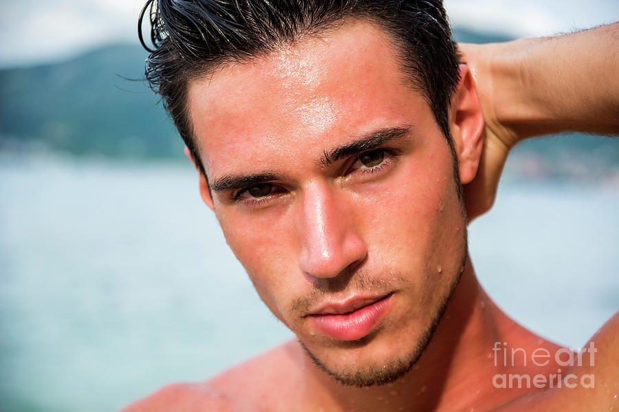Handsome young man getting out of water with wet hair Photograph by ...