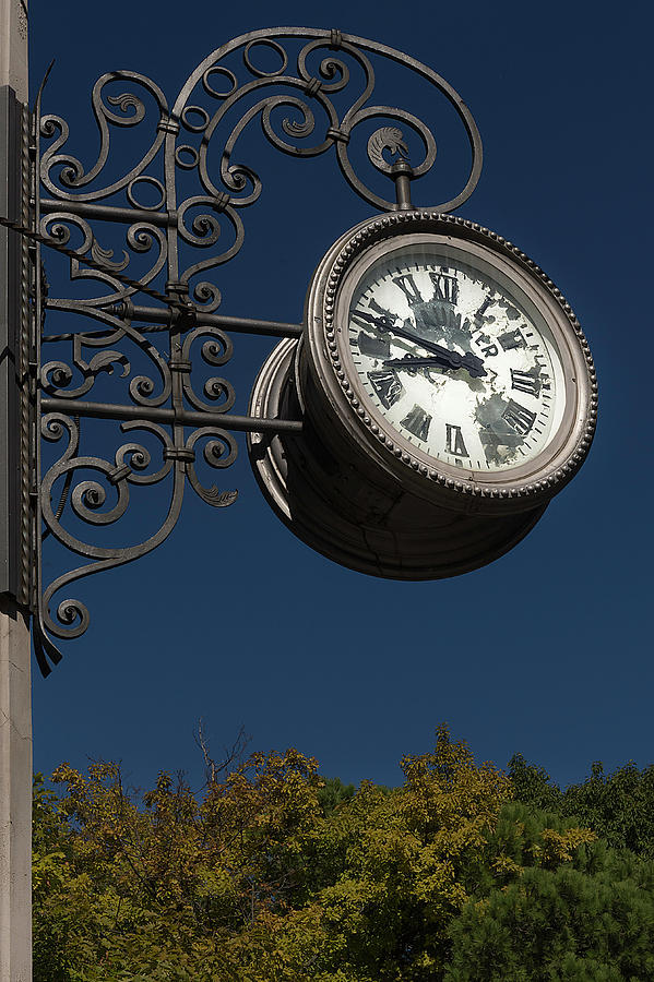 Hanging clock Photograph by Wolfgang Stocker