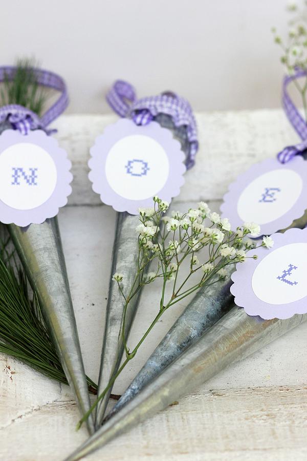 Hanging Vases With Letters On Purple Tags Reading noel When Put Together Photograph by Ruth Laing