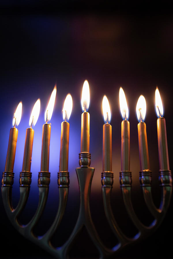 Hanukah Candles Lit In Menorah Against Colorful Background Photograph ...