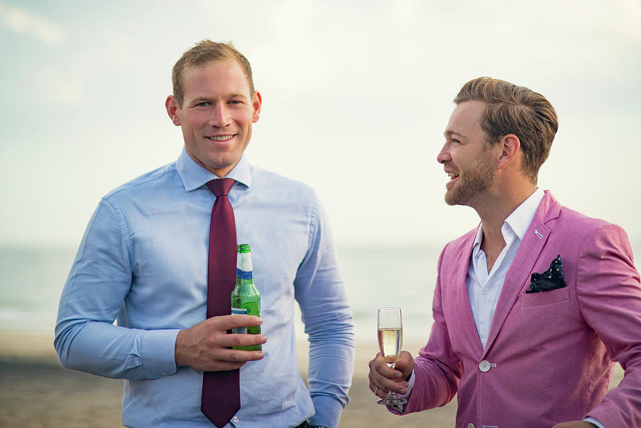 Nature Photograph - Happy Businessmen Holding Drinks On Beach by Cavan Images