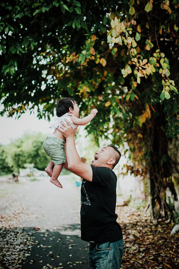 Happy Father Picking Up Son While Standing On Street Photograph by ...