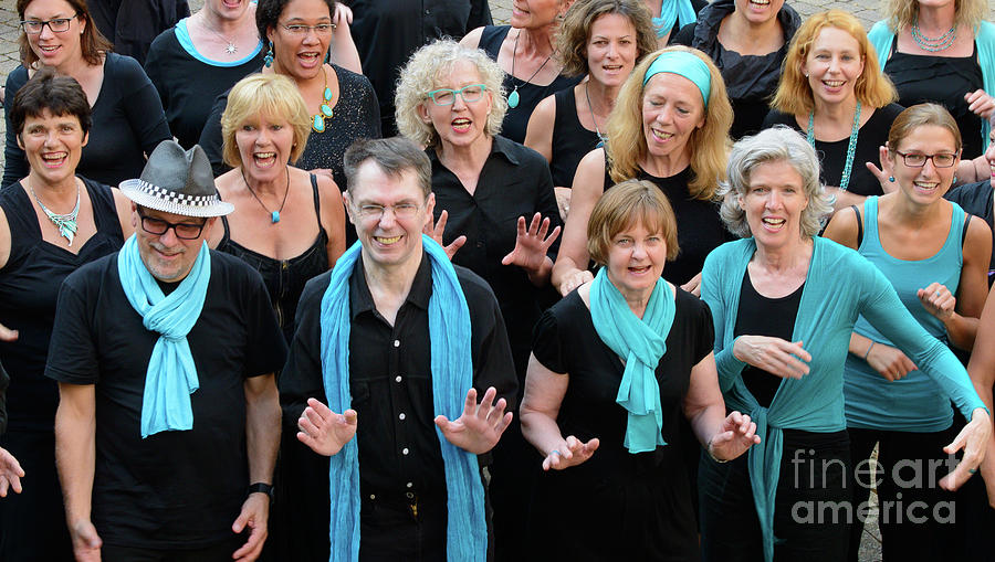Happy group of people is singing in a choir. Photograph by Ulrich Wende