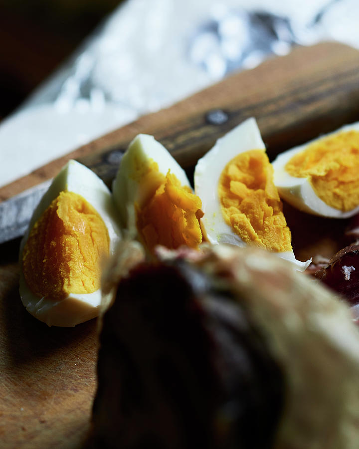 Hard-boiled Eggs In Wedges On A Wooden Board Photograph by Miha Lorencak
