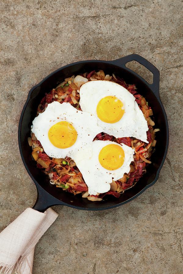 Hash Browns With Corned Beef And Fried Eggs Photograph by Renée Comet