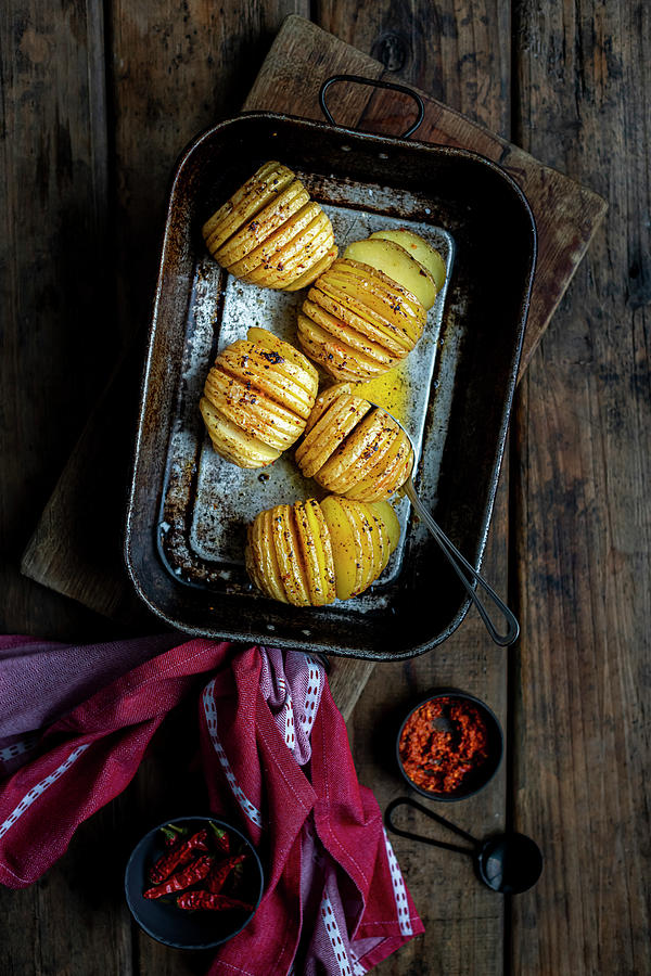 Hasselback Potatoes With Harissa Butter Photograph by Hein Van Tonder
