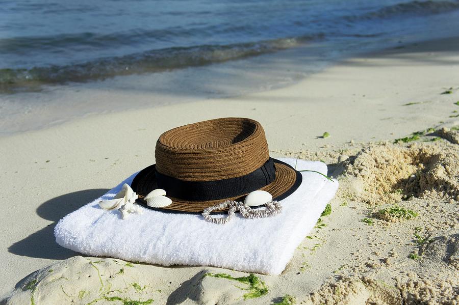 Hat And Towel On Sandy Beach Photograph by Martina Schindler