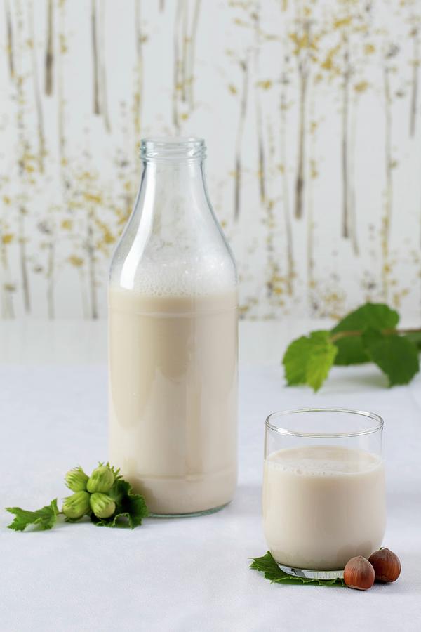 Hazelnut Milk And A Glass And In A Bottle Photograph by Lydie Besancon