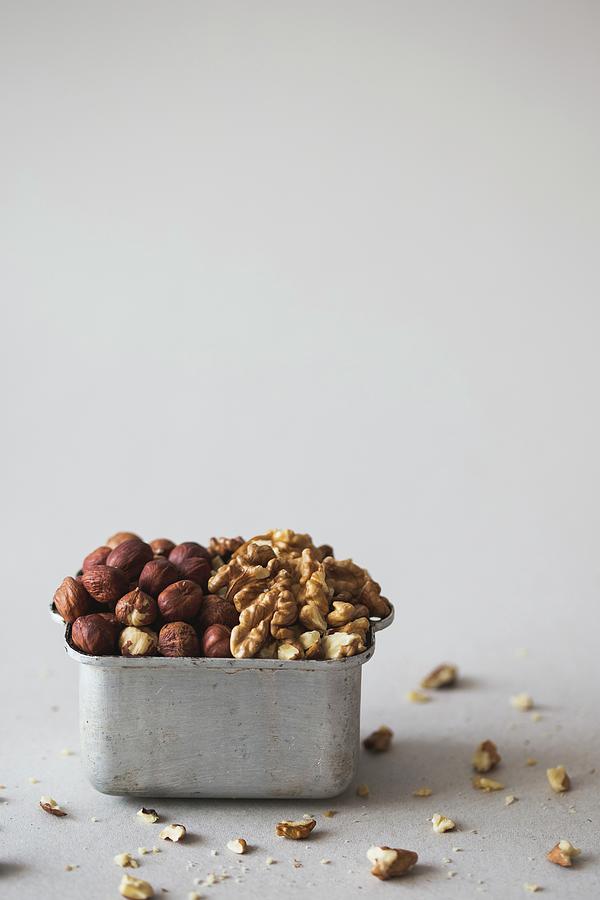 Hazelnuts And Walnuts In A Metal Container Photograph by Malgorzata Laniak