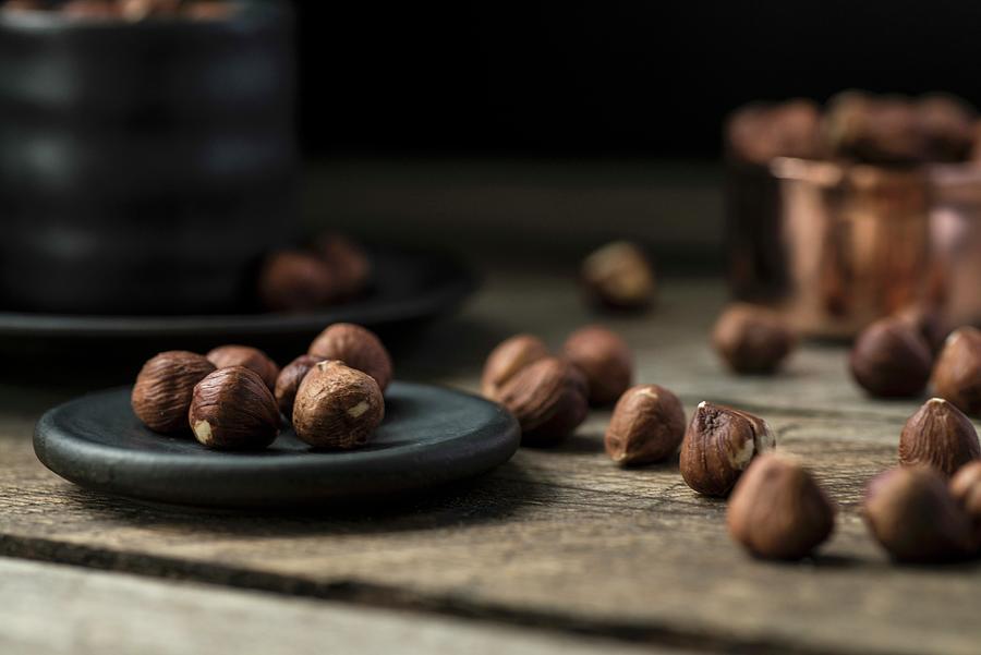 Hazelnuts On A Plate And In A Cup Photograph by Lixie Pott
