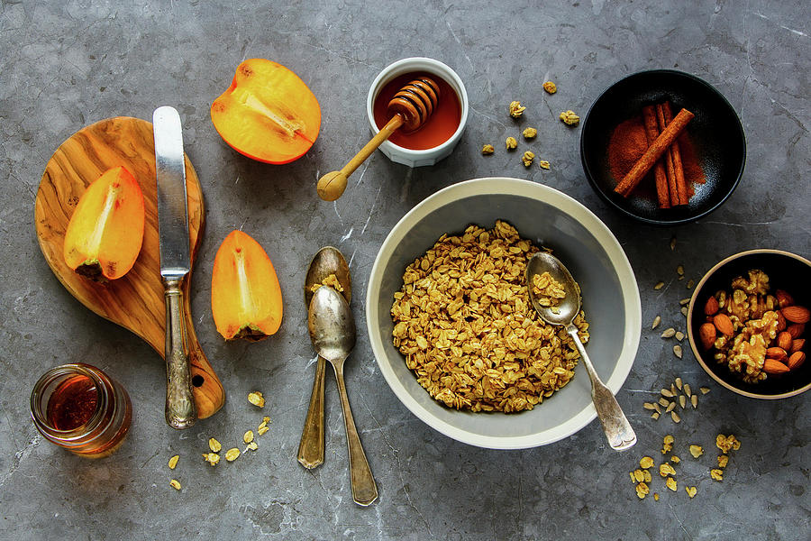 Healthy Breakfast Variety Of Cinnamon Granola, Fresh Persimmon, Maple Syrup, Honey And Nuts Photograph by Yuliya Gontar