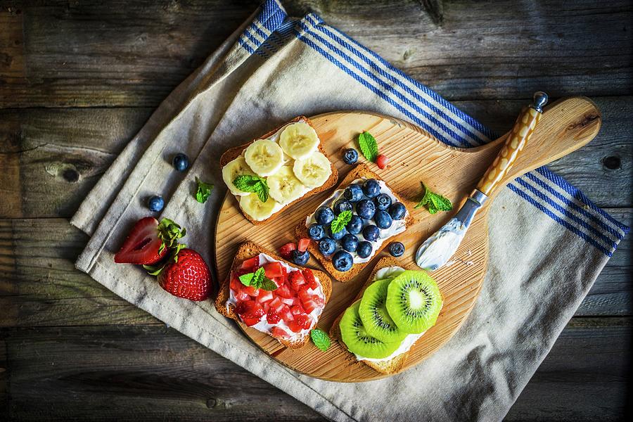 Healthy Fruit Open Sandwiches On A Wooden Board Photograph by Alena Haurylik