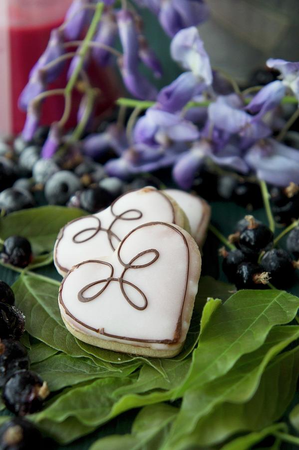 Heart Biscuits With Currant Jelly And An Icing Sugar Glaze Photograph by Martina Schindler