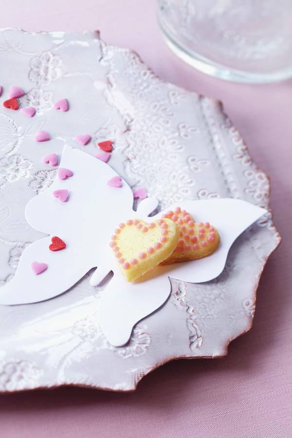 Heart-shaped Biscuits And Sugar Hearts On Paper Butterfly Photograph by Franziska Taube
