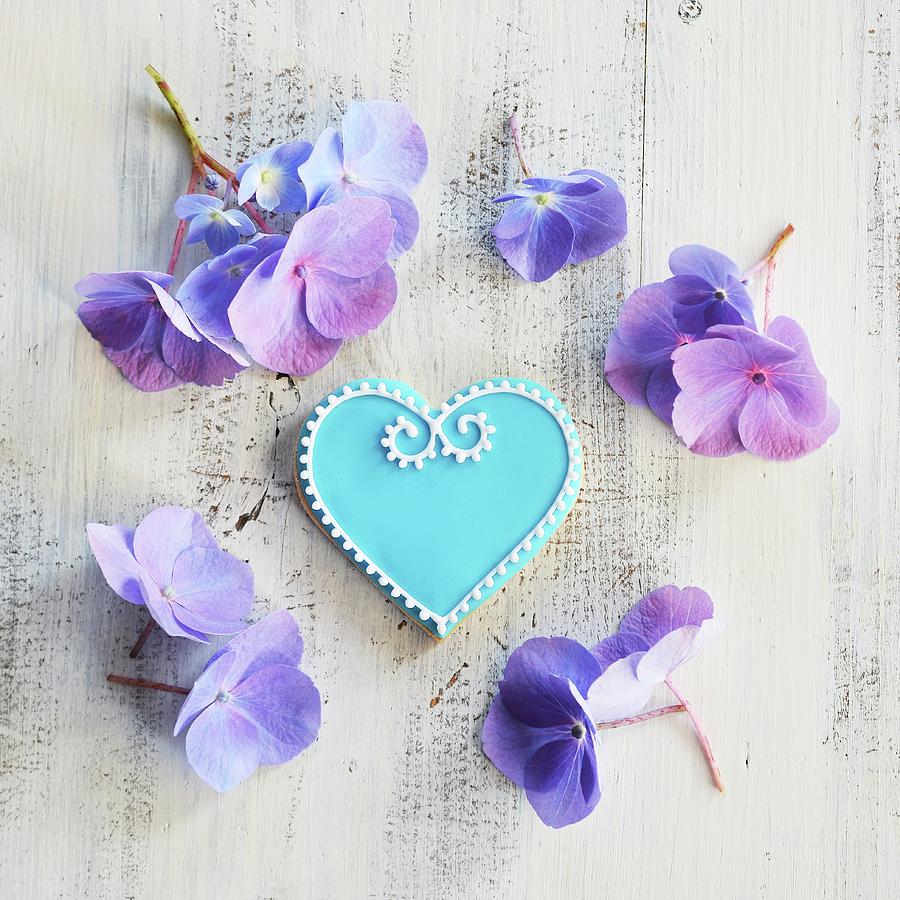 Heart-shaped Biscuits Decorated With Blue And White Icing And Surrounded By Flowers Photograph by Mariola Streim
