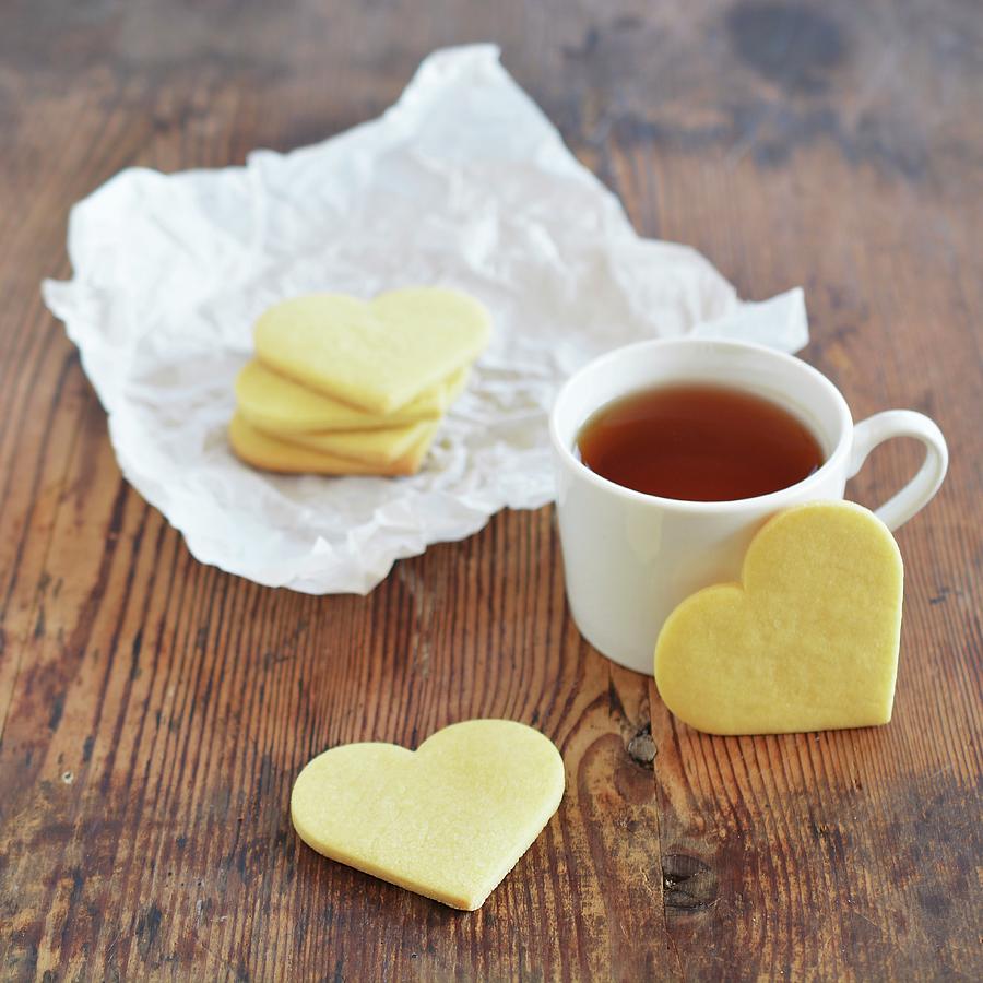 Heart-shaped Biscuits With A Cup Of Tea On An Old Wooden Table Photograph by Mariola Streim
