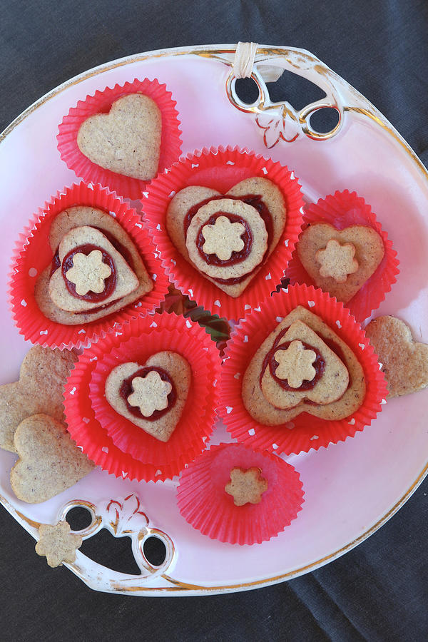 Heart-shaped Biscuits With Jam In Red Cake Cases Photograph by Regina Hippel